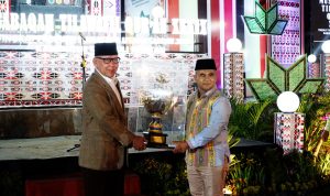 Asisten Kesra Kota Medan HM Sofyan saat menerima piala bergilir dari Pj Gubsu Agus Fatoni diwakili M Arman Efendy. BP/erwan