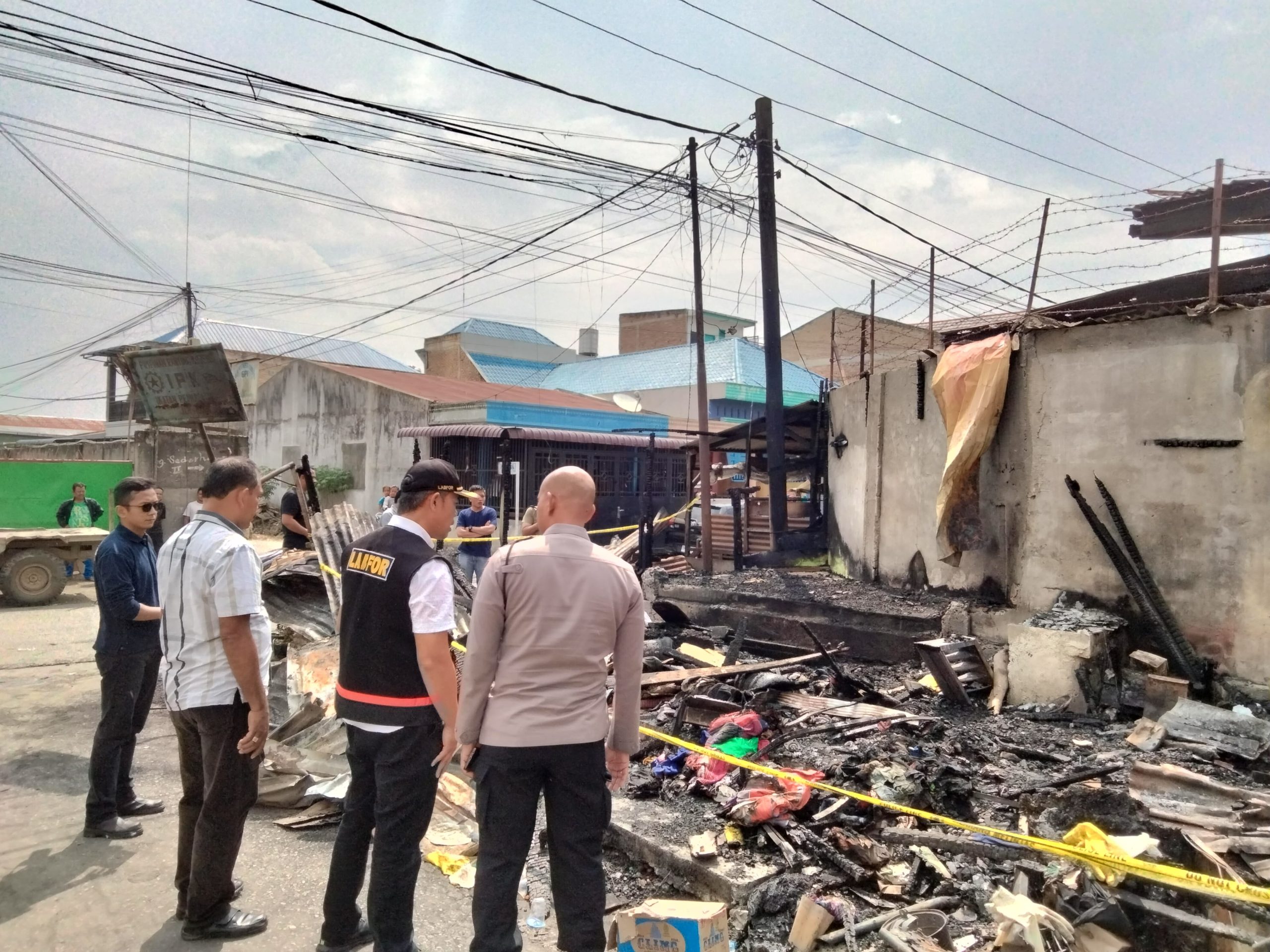 Pihak kepolisian ketika melakukan pemeriksaan di lokasi kebakaran di rumah wartawan di Tanah Karo.(Istimewa).