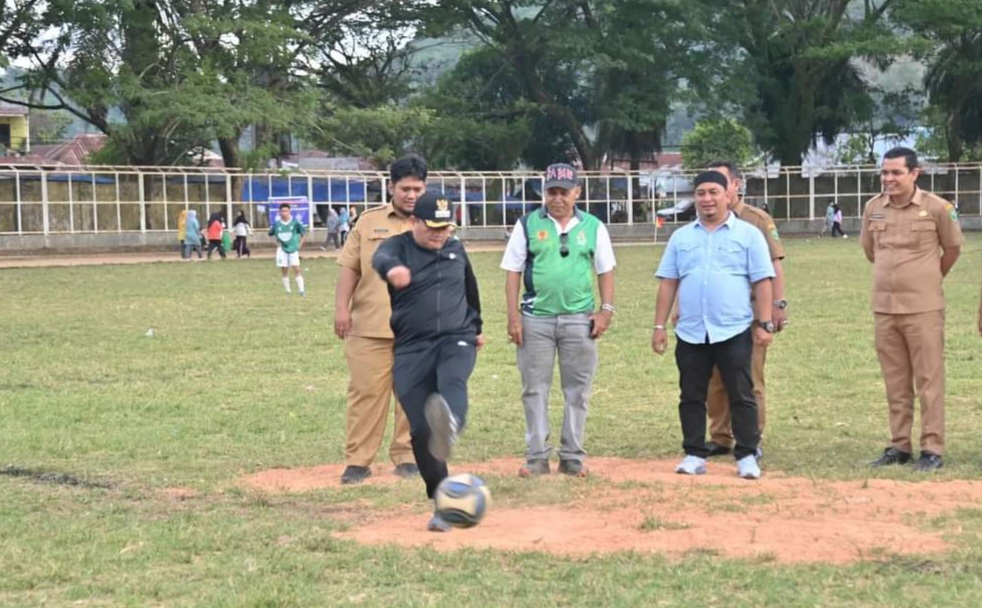 Pj Wali Kota Padangsidimpuan Timur Tumanggor didampingi Plt Ketua Askot PSSI Padangsidimpuan melakukan tendangan perdana tanda dimulainya turnamen sepakbola Suratin Cup di Stadion HM Nurdin, Senin (4/11-24). Foto : BP/Ist