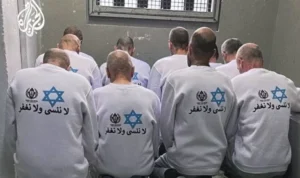 Tahanan Palestina yang dibebaskan memakai kemeja bertuliskan Kami tidak melupakan dan kami tidak memaafkan