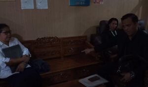 Tiopan Tarigan SH anak pasien sedang berkomunikasi dengan dokter di RS Djoelham Binjai.(Istimewa).