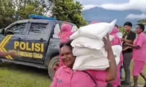 bayangkari di Papua mengangkat 5 karung beras yang beratnya per karung 5 kg (Lambeturah.co.id)