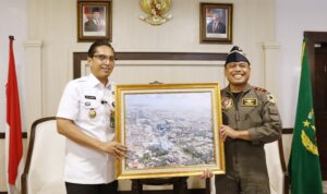 Wali Kota Medan Rico Wass saat menerima foto indah Kota Medan dari udara dari Komandan Batalyon Komando 469 Kopasgat. BP/ist