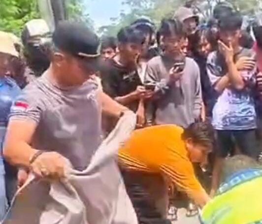 screenshot video Kapolsek Medan Tuntungan melepas baju dinasnya dan menutupi korban kecelakaan.(Istimewa)