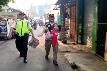 Satpol PP Kebayoran Lama membawa seorang anakkorban penyiksaan (Tempo.com)
